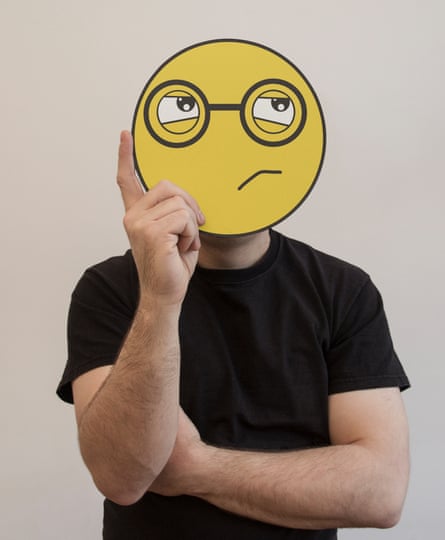 Man wearing a confused-face smiley mask