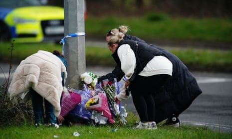 People lay flowers near the scene of the crash in Cardiff