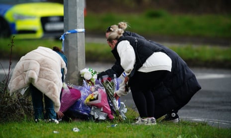 People leave floral tributes near the scene of the crash in Cardiff