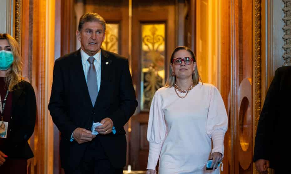 Joe Manchind and Kyrsten Sinema leave the Senate chamber after a vote on 3 November.