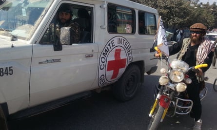 Taliban fighters driving a Red Cross vehicle in Kunduz