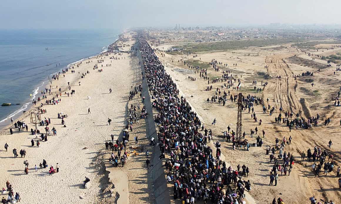 Displaced Palestinian people make their way back to their homes in northern Gaza on 27 January