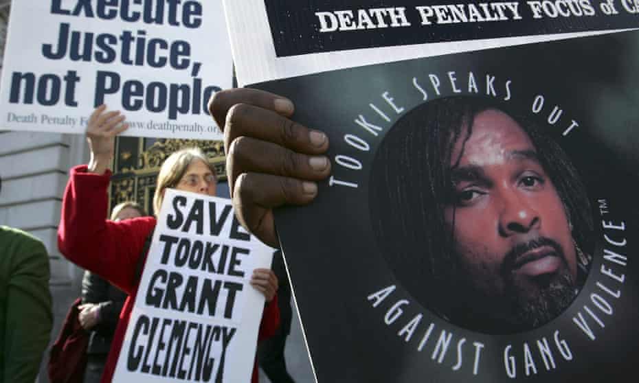 Opponents of the death penalty carry signs during a rally asking for Stanley ‘Tookie’ Williams to be spared of the death penalty in 2005.