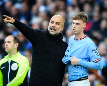 Pep Guardiola gives touchline instructions to Cole Palmer.
