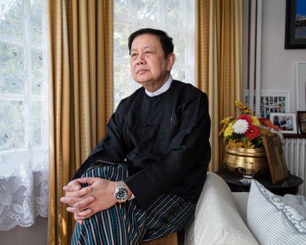 Kyaw Zwar Minn sitting on the back of a sofa