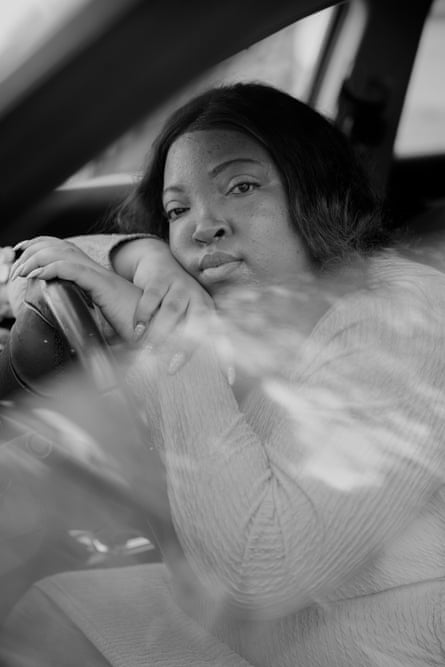 A woman in the driver’s seat of a car.
