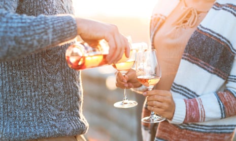 A couple with glasses of rosé
