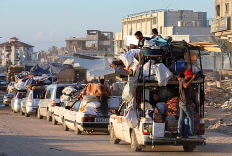 A long line of displaced Palestinians who have fled Rafah