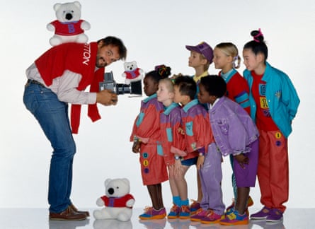 Toscani points his camera at a group of children wearing colourful clothing