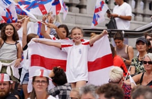 A girl holds the England flag aloft
