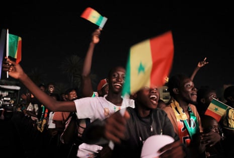 Fans watching at the Obelisk Square in Dakar, celebrate after Senegal's Ismaila Sarr scores their second goal.