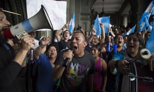 Demonstrators shout slogans against Guatemala’s President Jimmy Morales at the National Palace of Culture in Guatemala City.