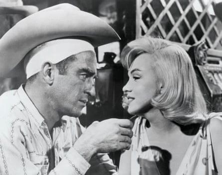 Montgomery Clift as buck-drunk bronco rider Perce Howland with Monroe.
