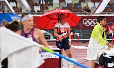 Britain’s Holly Bradshaw shelters from the rain under an umbrella during the women’s pole vault qualification at Tokyo 2020 Olympic Games.