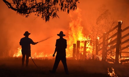 Residents defend a property from a bushfire at Hillsville near Taree, 350km north of Sydney