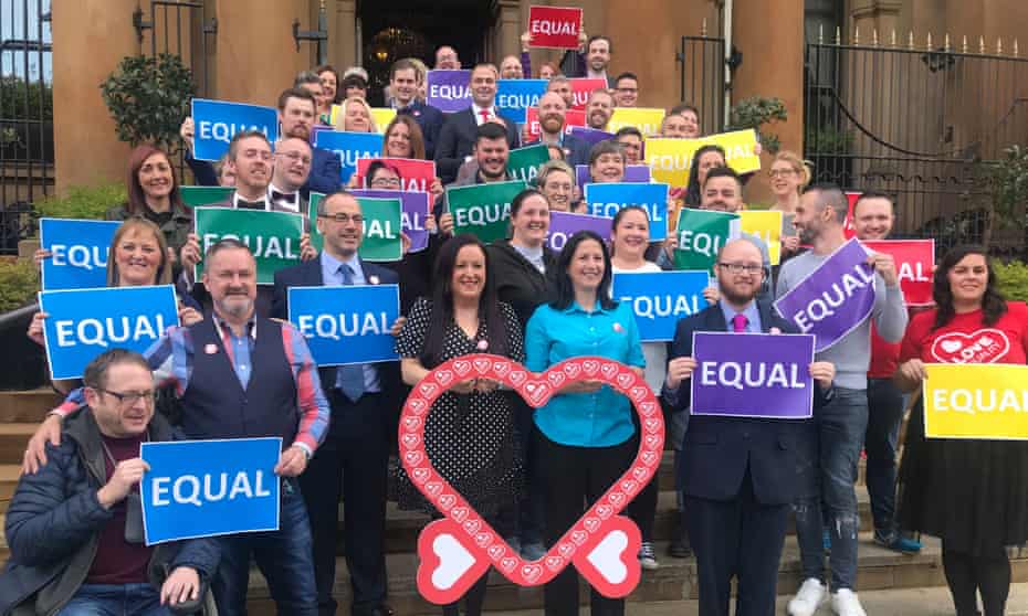 Crowds of campaigners on steps holding up signs reading: 'Equal'