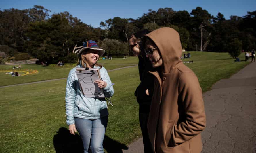 Teresa McGlashan, a volunteer for the Prevent Cruelty California campaign (and is also a marriage and family therapist based in Mill Vally), talking to two women about the campaign in Golden Gate Park, San Francisco.