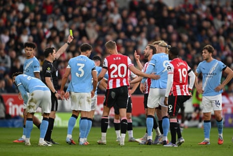 Henderson is shown a yellow card by Referee Darren England.