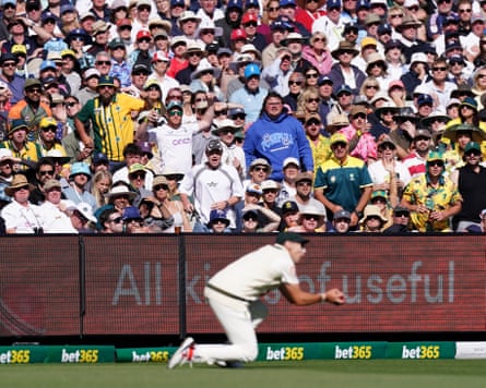 Fans look on as Australia’s Scott Boland takes a catch