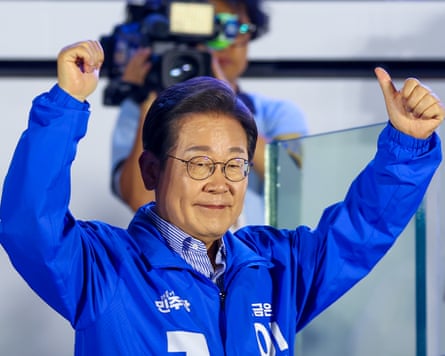 Lee Jae-myunga with arms in air