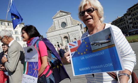 A woman holds up a placard ahead of a speech by Theresa May in Florence.