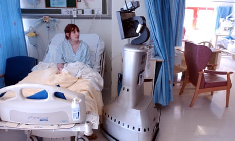 A remote control device next to a patient in bed in a surgical ward