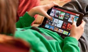 A boy watches Netflix on his tablet