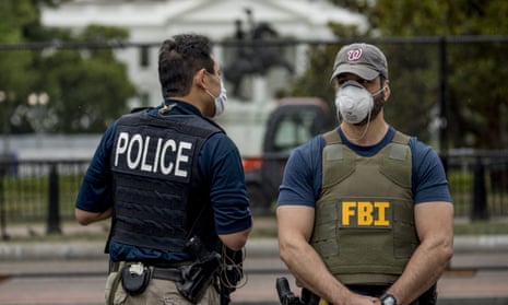 The White House is visible behind a large security fence as uniformed Secret Service and FBI agents stand on the street in front of Lafayette Park in the morning hours in Washington, Tuesday, June 2, 2020, as protests continue over the death of George Floyd. Floyd died after being restrained by Minneapolis police officers. (AP Photo/Andrew Harnik)