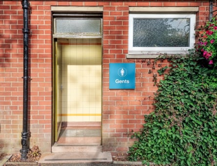 An exterior view of the gents entrance to a traditional public toilet building in the UK.