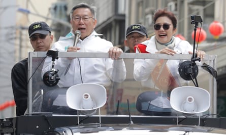 The Taiwan People’s party (TPP) presidential candidate Ko Wen-je (second left), holds a microphone as he delivers a speech on a car during a campaign rally