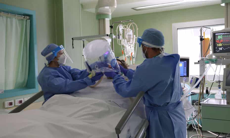 Doctors and nurses wearing protective suits and masks at work inside the intensive care unit of the Bolognini hospital in Seriate, northern Italy.