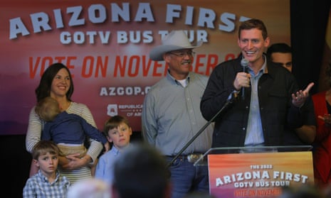 Republican candidate for the US Senate Blake Masters speaks in front of his family and Republican candidate for Arizona secretary of state, Mark Finchem, during a campaign stop in Tuscon.
