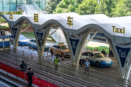 Taxis wait for fares outside the airport in Wuhan, China.