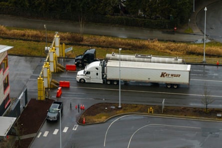 Aerial view of two semis stopped on a rainy road