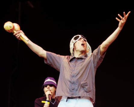 Bez with his arms raised and maracas in one hand at Glastonbury in 2000.