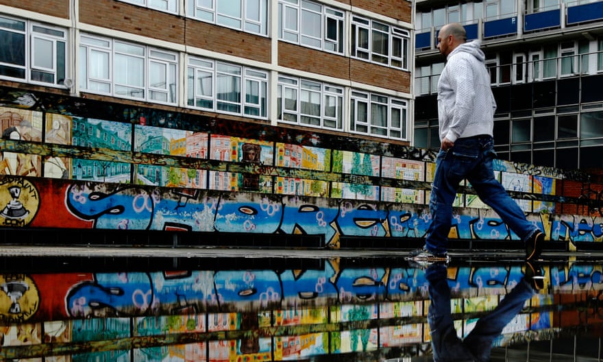 A man passes graffiti near Old Street’s ‘Silicon Roundabout’ technology hub in Shoreditch, east London.