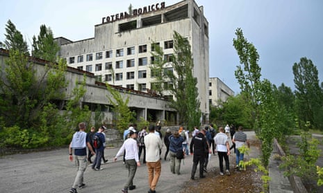 Visitors walk in the ghost city of Pripyat during a tour in the Chernobyl exclusion zone in June.