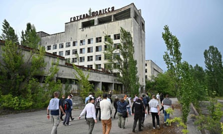 Visitors walk in the ghost city of Pripyat during a tour in the Chernobyl exclusion zone.