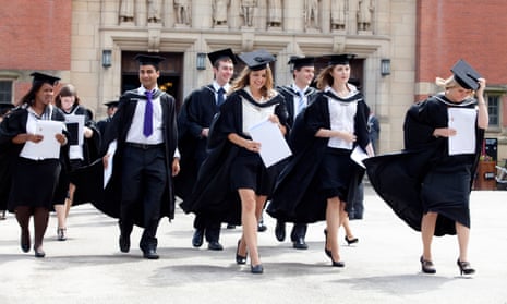 Graduates leave the Great Hall after a degree ceremony at Birmingham University UK.