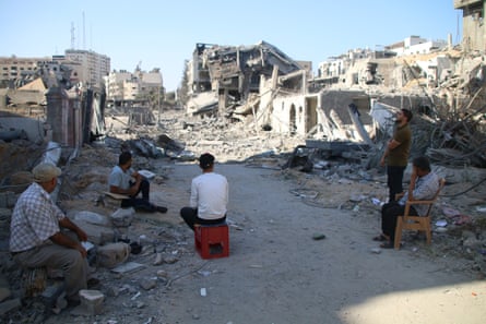 Palestinian citizens inspect damage to their homes caused by Israeli airstrikes in Gaza City.