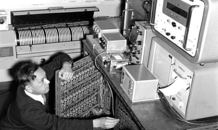 Dr Shizuo Ishiguro with his electronic analogue machine, which converted meteorological and ocean data into electrical signals on a series of wire meshes. This allowed the height of storm surges, and where and when they would make coastal impact, to be predicted.