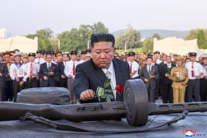 Kim Jong-un lays a rose on top of a memorial