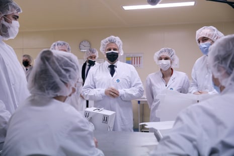 French President Emmanuel Macron, centre, at the vaccine production facility.