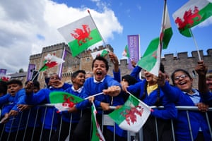 School children wait for King Charles III to arrive at Cardiff Castle