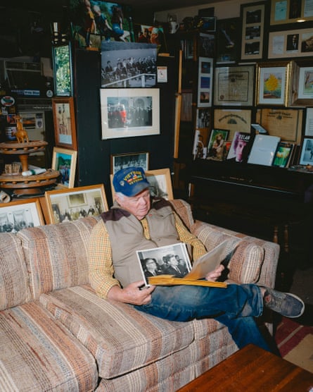 Man sits on sofa and looks through old photos