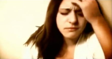 film still of woman holding head in her hands