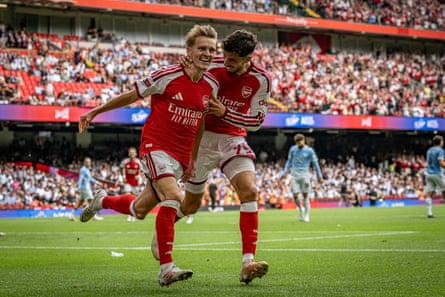 Martin Ødegaard celebrates with Kai Havertz after scoring Arsenal’s third goal against Manchester City