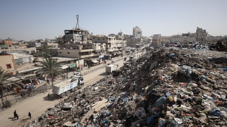 Road with vehicles, piles of rubble to the side