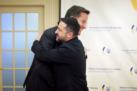 Zelenskyy and Rutte hugging.