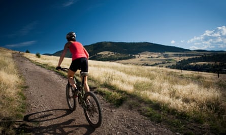 A female mountain biker pedals the trail on Mt. Sentinel, Missoula, Montana.